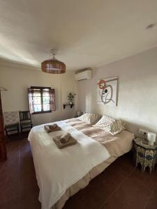 a bedroom with a large bed with towels on it at Casa La Nuez in Almedinilla