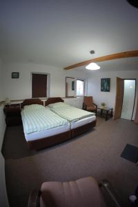 a bedroom with a large bed in a room at Penzion Černý mlýn in Březová