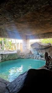 a pool of blue water in a cave at Afrika Lodge in Kempton Park