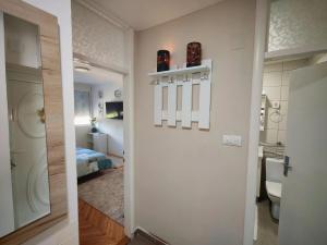 a hallway with a bathroom and a room with a bed at Apartman ANA in Pirot +43 photos