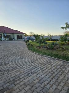 a brick driveway in front of a house at Nana Kay's apartment in Livingstone
