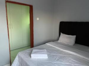 a bedroom with a bed with a mirror next to it at Nana Kay's apartment in Livingstone