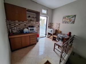 a kitchen with a sink and a table with a microwave at Jannis Castle Apartment in Himare