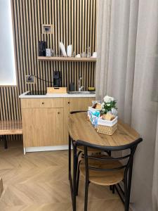 a table and chairs in a kitchen with a sink at La Dea Fuoco in Torre del Greco