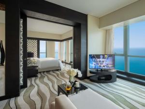 a hotel room with a bed and a television at Sofitel Abu Dhabi Corniche in Abu Dhabi