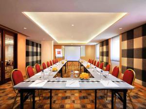 a large conference room with a long table and chairs at Ibis Bali Kuta in Kuta