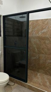 a glass shower in a bathroom with a toilet at Dk Casa in Lusaka +26 photos