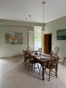 a dining room with a wooden table and chairs at Le Sart de Bouland in Frasnes-lez-Anvaing