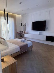 a bedroom with a bed and a flat screen tv at La Dea Fuoco in Torre del Greco