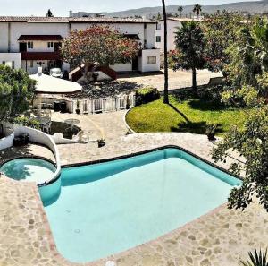 a blue swimming pool in the middle of a yard at Ocean view house - Plaza del Mar in Rosarito