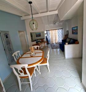 a dining room table and chairs in a living room at Ocean view house - Plaza del Mar in Rosarito