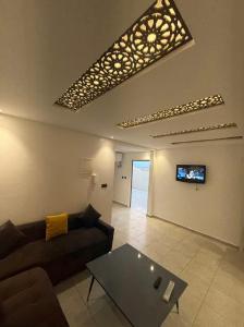 a living room with a couch and a table at Hostel the little prince in Tarfaya