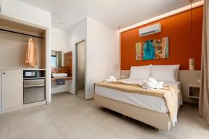 a bedroom with a large bed with an orange headboard at Madison Boutique, Faliraki in Faliraki