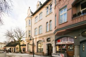 a tall building with a clock tower on a street at Sopot Monte Cassino Wiktoria Apt in Sopot