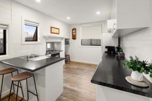 a kitchen with a sink and a counter top at Queenie's Cottage in Mansfield +10 photos