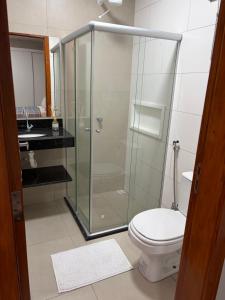 a bathroom with a shower with a toilet and a sink at Residencial Bom Sossego Apto 01 in Itabuna +7 photos