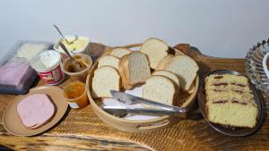 a table with a tray of bread and other foods at Refúgio Vida & Brisa in Pelotas
