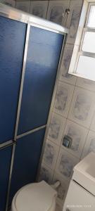 a bathroom with a toilet and a window at Apê d'praia 31 - Beira Mar Bertioga in Bertioga