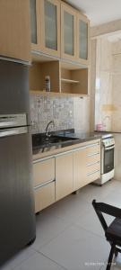 a kitchen with a sink and a stove at Apê d'praia 31 - Beira Mar Bertioga in Bertioga +13 photos