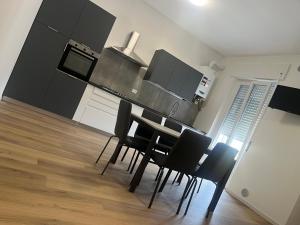 a kitchen with a table and chairs in a room at La casa dello zio in Vasto