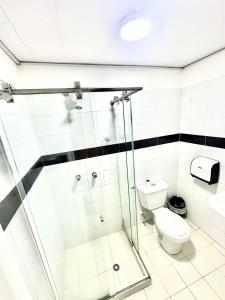 a bathroom with a shower and a toilet at hotel guayacanes central in Medellín +17 photos