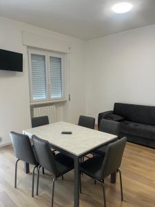 a table and chairs in a living room with a couch at La casa dello zio in Vasto