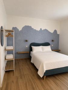 a bedroom with a blue and white bed and a shelf at Minnanni in San Pantaleo +27 photos