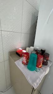 a shelf with cups and other items on it at Casa do Mascarenhas in Picos +1 photo