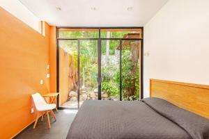 a bedroom with a bed and a sliding glass door at Beautiful private villa with an ecological pool in Santa Maria Huatulco +72 photos