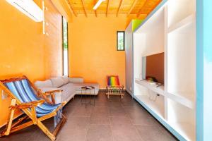 a living room with a couch and a tv at Beautiful private villa with an ecological pool in Santa Maria Huatulco