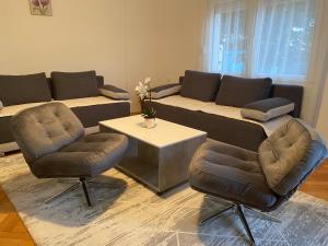 a living room with a couch and two chairs and a table at Sladjana apartman in Prijepolje