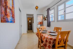 a dining room with a table and four chairs at Dar Tilila in Essaouira +59 photos