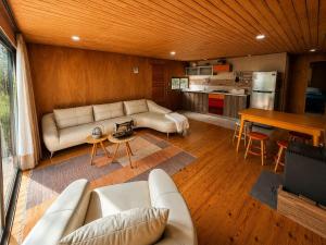 a living room with a couch and a table at Santuario Lodge Arrayan in Lo Barnechea