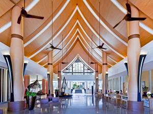 a large lobby with wooden ceilings and ceiling fans at Grand Mercure Phuket Patong in Patong Beach