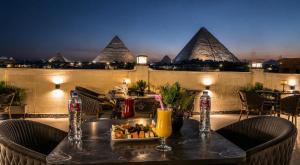 a table with a tray of food and drinks on a balcony at King's Gate Pyramids Horizon in Cairo