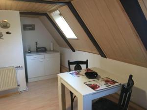 a dining room with a table and a kitchen at Maria Ferienhaus in Wernigerode