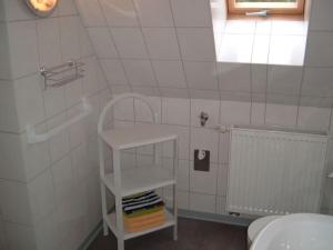 a bathroom with a white shelf in a room at Maria Ferienhaus in Wernigerode +38 photos