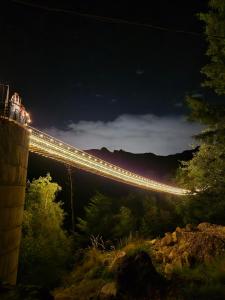 a bridge lit up at night with people on it at Chalet Cuarzo in Mineral del Chico