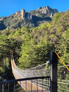 a swinging bridge on a mountain with trees at Chalet Cuarzo in Mineral del Chico