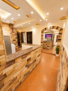 a kitchen with a stone wall and a counter at Hadayek Al-Ahram Guest House - حدائق الاهرام جيست هاوس in Giza