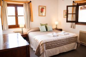 a bedroom with a bed and two windows at La Domanda Hostería in Villa Berna +77 photos