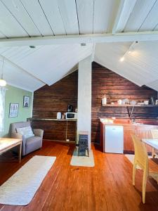 a large living room with a table and a kitchen at Cottage from 1850 in Ballstad in Ballstad
