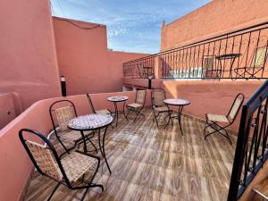 a patio with tables and chairs on a balcony at Riad Al Anwar in Rabat