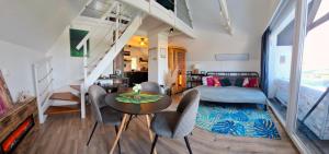 a room with a bed and a table and chairs at Hillside Cottage in Pécs