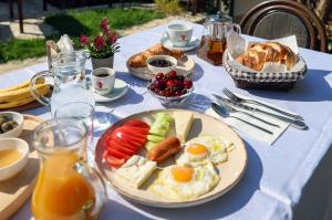 a table with a plate of breakfast food on it at Guest House Nina in Berat
