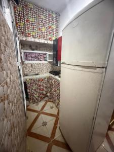 a kitchen with a refrigerator in a room at Katalan in Martil