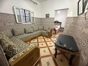 a living room with a couch and a table at Katalan in Martil