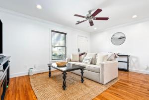 a living room with a couch and a ceiling fan at Saturdays In The South in Auburn