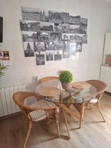 a dining room with a glass table and chairs at CASA RAMI especial parejas in San Martín del Rey Aurelio