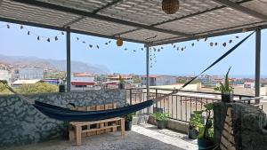a hammock on a balcony with a view at Ka'Zinha Guesthouse - Chambres d'hôtes Tarrafal in Tarrafal +13 photos